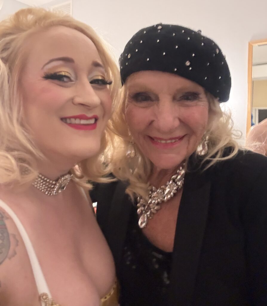 two showgirls posing backstage