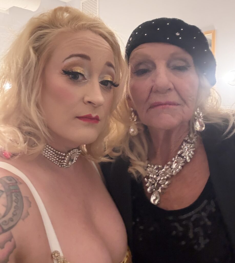 two showgirls serving face backstage